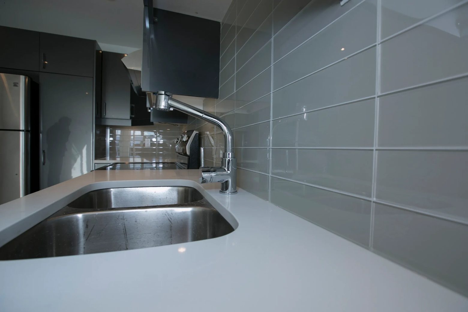 A kitchen with marble countertops and the faucet